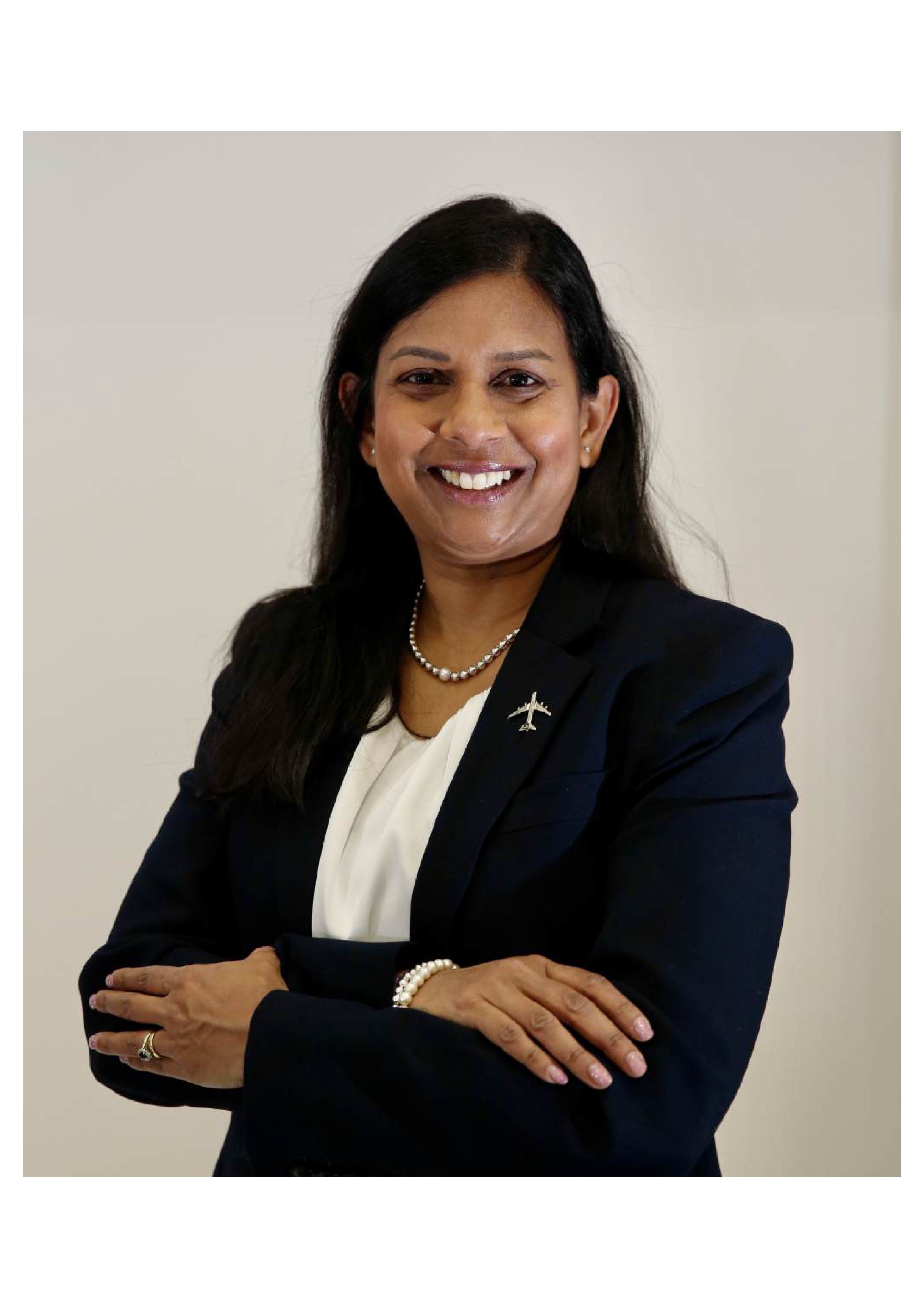 Professional photo of Aegis Professor Loraine McIlree, smiling at the camera.